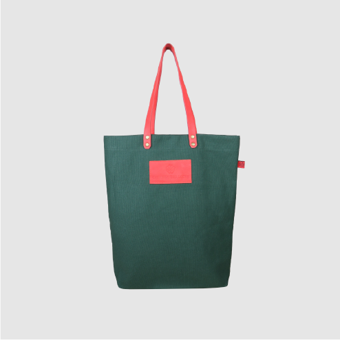 Custom premium tote bag in green canvas and pink leather handles and logo badge