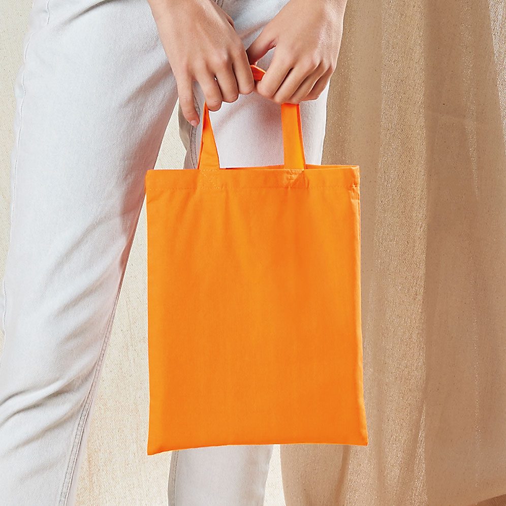 Woman Holding Orange Mini Bag For Life Tote – A4 Size