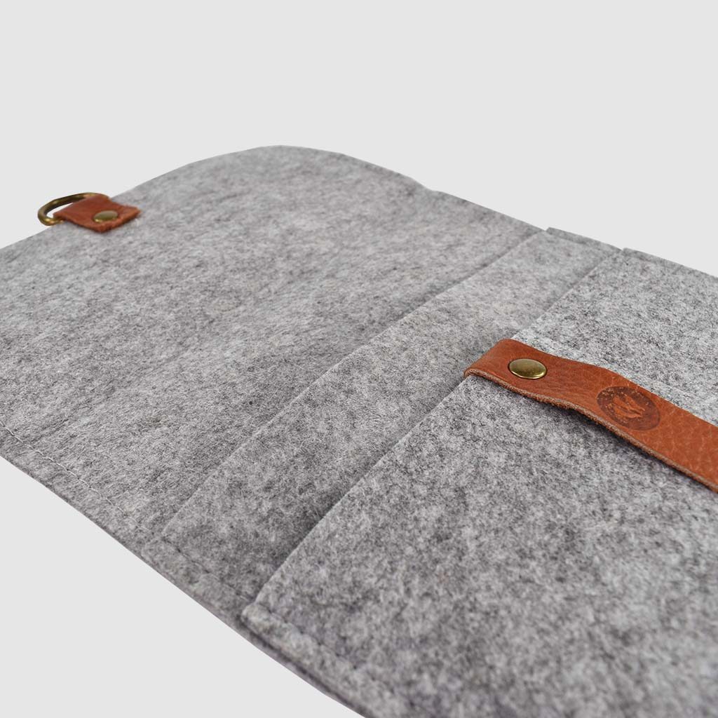 open grey felt folder with brown leather strap