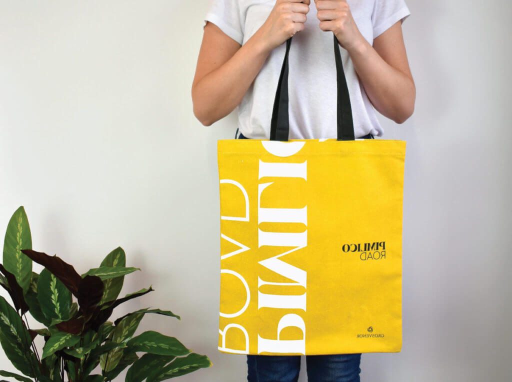 custom bag overprinted yellow held by model