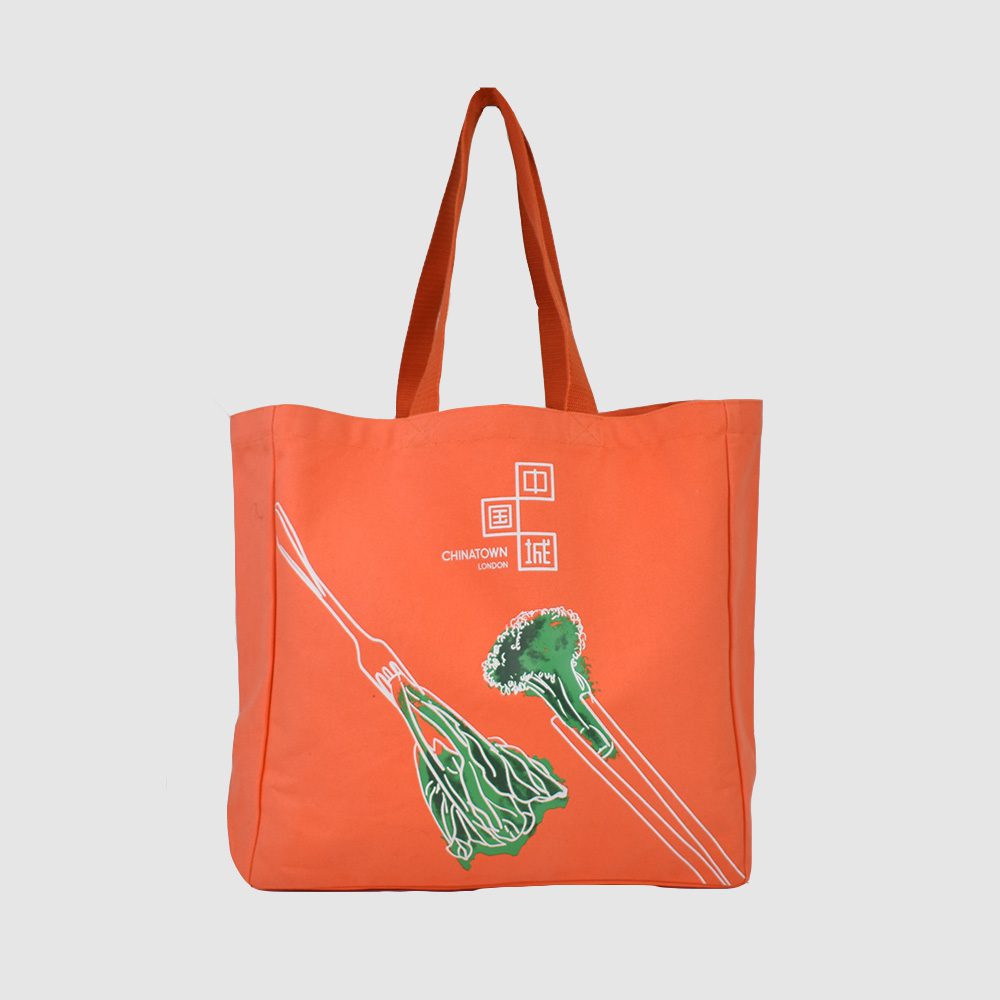 green packaging an eco friendly orange canvas bag with green broccoli
