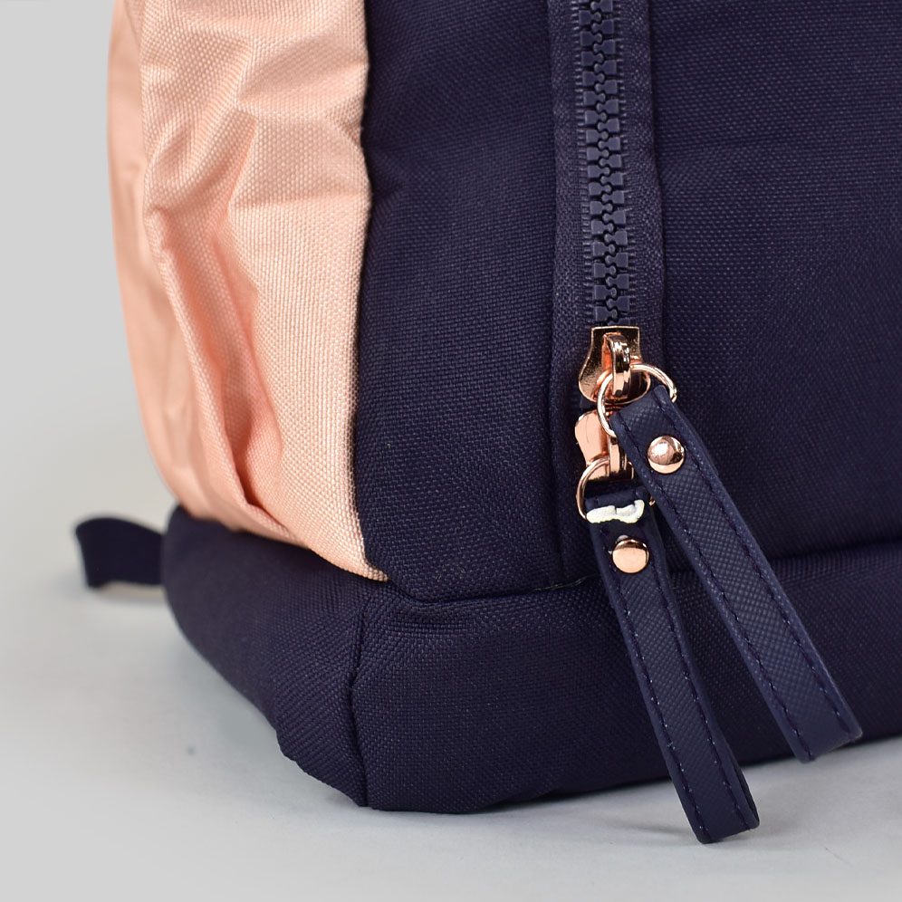 navy blue picnic bag with pink side pocket and pink adjustable buckles side view with rose gold zip pull detail