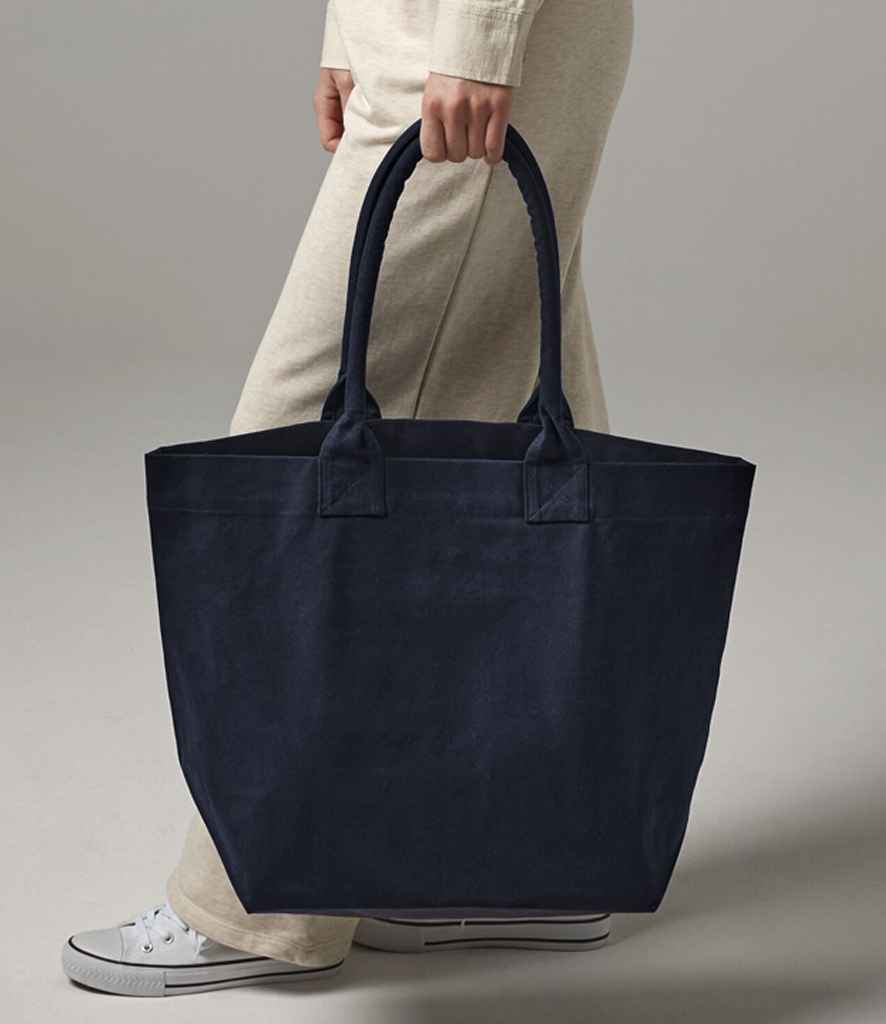 navy boat bag with short handles being carried by person