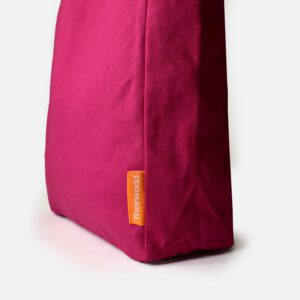 side panel of pink A4 bag with orange woven logo label