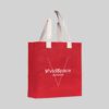 square red jute bag with natural coloured short hand carry handles
