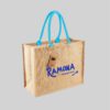 square shaped brown jute bag with blue rolled handles