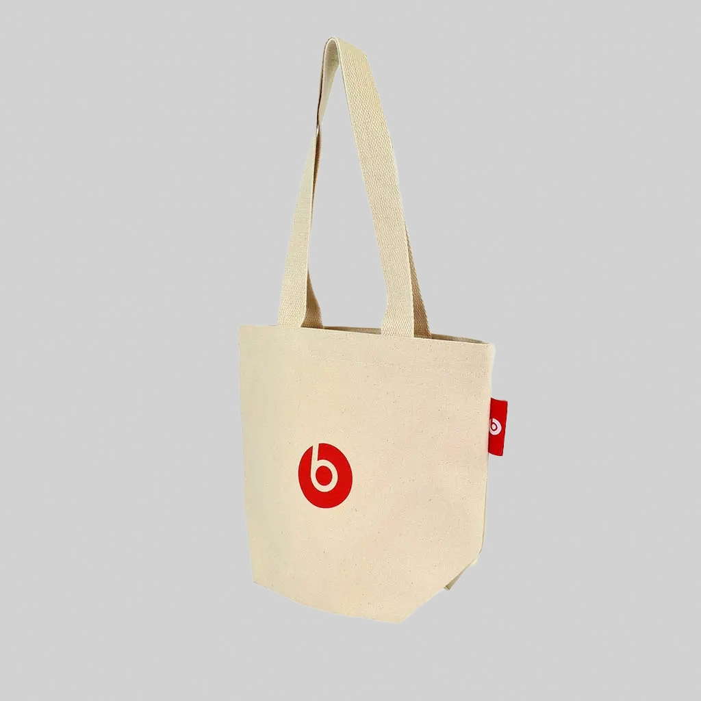 natural tote bag with Beats by Dre red logo on the bag and red woven label
